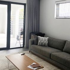 a living room filled with furniture and a sliding glass door