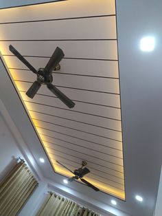 a ceiling with lights and fan in the middle