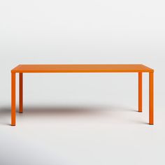 an orange rectangular table sitting on top of a white floor