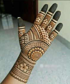 a woman's hand with henna on it