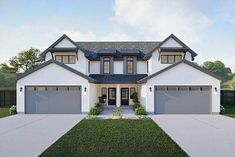 a white and gray house with two garages