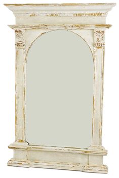 an old white wooden mirror frame with carvings on the top and bottom edge, against a white background