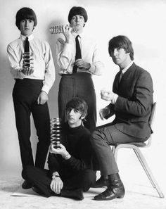 the beatles posing for a black and white photo with their hair combs in their hands