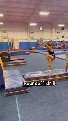 some people are doing tricks on trampolines in a gym