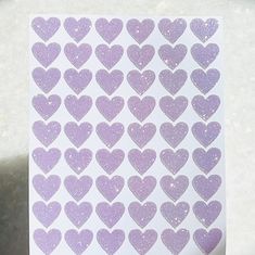 purple glitter hearts stickers on white paper