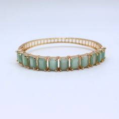 Enhance your jewelry collection with our stunning aqua chalcedony gemstone gold bangle bracelet. This elegant piece is perfect for any occasion, adding a touch of sophistication to your look. ✨ Handcrafted with precision and care 💎 Features genuine aqua chalcedony gemstones 🌟 Gold-plated for a luxurious finish 🎁 Ideal gift for birthdays, anniversaries, and special occasions 🛍️ Versatile accessory suitable for both casual and formal wear 📏 Adjustable size for a comfortable fit 💎 High-quality materials ensure lasting beauty Perfect for treating yourself or as a thoughtful gift, this handmade bangle bracelet is a timeless addition to any jewelry collection. - Material: Aqua Chalcedony Quartz, Gold Plating - Weight : 15gm - Stone Shape: Rectangular - Stone Color: Aqua Green - Bracelet Di Luxury Gemstone Bangle Bracelet, Handmade Bangle Bracelets, Gemstone Bangle, The Bangles, Gold Plated Bangles, Color Aqua, Aqua Chalcedony, Wedding Jewelry Bracelets, Wedding Bracelets