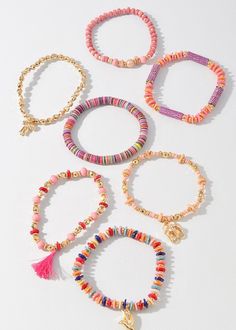 Add a touch of whimsy to your accessory game with our Beaded Charm & Shell Bracelet Set. Each bracelet features a unique assortment of colorful beads and charming puka shells. Perfect for those who like to mix and match for a playful and fun look. Multicolor Heishi Beads Bracelets For Vacation, Playful Colorful Beaded Bracelets For Vacation, Playful Heishi Beads Bracelets For Beach, Pink Heishi Beads Friendship Bracelets For Vacation, Playful Multicolor Beaded Bracelets For Vacation, Playful Heishi Bead Bracelets With Colorful Beads, Adjustable Beaded Bracelets With Charms For Beach, Pink Heishi Beads Bracelets For Vacation, Playful Heishi Bead Friendship Bracelets With Colorful Beads