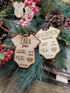 two wooden christmas ornaments with names and date on them