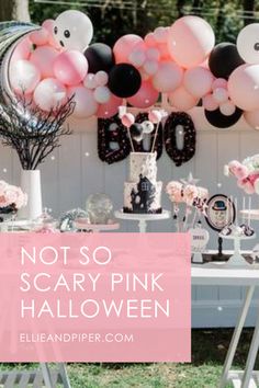 an outdoor party with balloons, cake and decorations for a scary pink halloween themed party