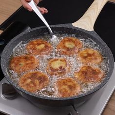 a pan filled with fried food on top of a stove