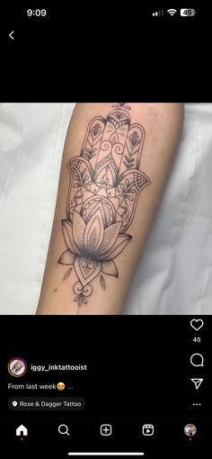 a person with a tattoo on their arm that has an image of a hamsa