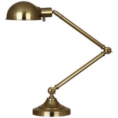 an antique brass desk lamp on a white background