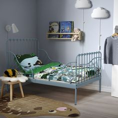 a child's bedroom with a blue metal bed