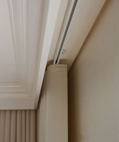 the corner of a room with a white door handle