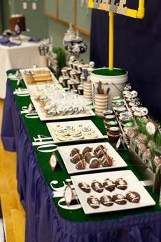 a table topped with lots of desserts and cupcakes