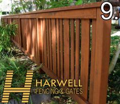 a wooden fence surrounded by plants and trees