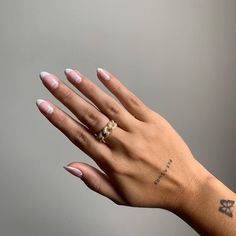 a woman's hand with two rings on her left and one ring on her right