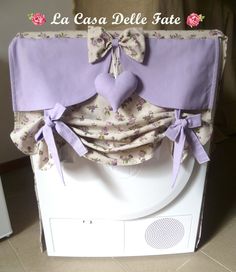 the back of an oven covered in purple fabric with bows and hearts on it's side