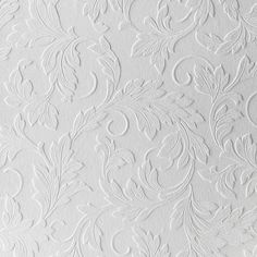 white wallpaper with an intricate design on it's surface and the background is painted in