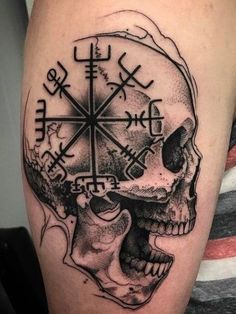 a man's arm with a skull and cross tattoo on it