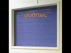 a blue roller up door with the word dorotec written on it in orange