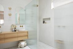 a bathroom with a sink, mirror and walk in shower