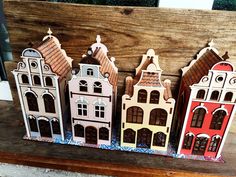 four wooden buildings are sitting on a table