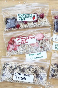 four bags of granola are sitting on a table with labels for different types of granola