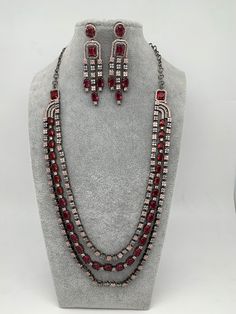 AD Wine Red Stone Multi Layer Victorian Finish Long Necklace with Matching EarringsColor : VictorianSize : Necklace Length : Approx 24 Inches; Earring Length : 2.75 inches;Stones : AD Wine Red Stone Red Metal Jewelry Sets For Party, Exquisite Red Oval Necklace, Red Multi-stone Jewelry, Red Handmade Victorian Necklace, Red Multi-strand Necklaces With Natural Stones, Luxury Red Multi-stone Necklaces, Red Stone, Wine Red, Social Events