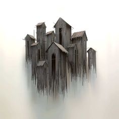 an image of a group of buildings made out of sticks on the ground with fog