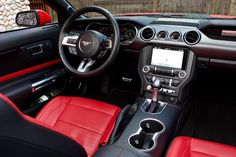 the interior of a sports car with red leather seats and black trims is shown