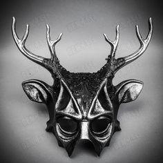 Mystery and allure with our Antler Deer Textured Horn with Laces Devil Halloween Masquerade Mask in Black. Perfect for anyone seeking an unforgettable Halloween costume or masquerade accessory, this mask combines the wild elegance of antler deer horns with the mysterious charm of a masquerade. Crafted from durable plastic, the mask features a textured design that mimics the aged look of antique artifacts, painted in a popcorn-textured black to enhance its appeal. Measuring approximately 14 inche Gothic Masks And Prosthetics For Halloween Theater, Horned Masquerade Mask For Halloween Cosplay, Gothic Horned Masquerade Mask For Costume Party, Fantasy Horned Masquerade Mask For Costume, Gothic Masquerade Mask For Halloween Theater, Novelty Masks And Prosthetics For Halloween Masquerade, Themed Black Masquerade Mask For Halloween, Horned Fantasy Masquerade Mask For Halloween, Silver Costume Accessories For Halloween Fantasy Events