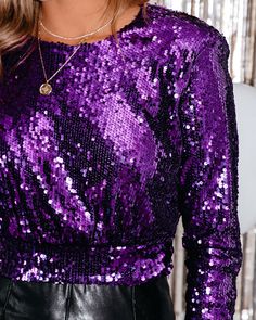 Relaxed Fit Ground Fabric & Lining¨C 100% Polyester and Sequins¨C 100% Polyethylene Hand Wash Cold. Line Dry Crew Neckline Long Sleeves Padded Shoulders Elastic Waistband Sequin Fabrication Back Keyhole with Neckline Button Closure Fully Lined Our Lavern Sequin Padded Crop Blouse demands attention! This purple sequin top features chic padded shoulders. Designed with an elastic waistband and a crew neckline. Secured with a back keyhole closure. Styled with the Roxy Hoops. Snake Collar Necklace. Chloe Mini Necklace. Compass Coin Necklace. Simple Bangle Bracelet. Chic Crossbody Chain Pouch Bag. Sterling High Rise Faux Leather Pants. and Bella Faux Leather Strappy Kitten Heel.---SIZE AND FIT---Model is Wearing a Size Small. Height is 5'9". Bust is 32". Waist 24.5". and Hips 34" Size XS: Length Purple Sequin Top, Off Shoulder Evening Gown, Simple Bangle, Mini Necklace, Purple Sparkle, Mini Skater Dress, Distressed Denim Jacket, Cropped Denim Jacket, Purple Top