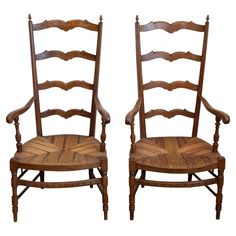 two wooden chairs sitting side by side