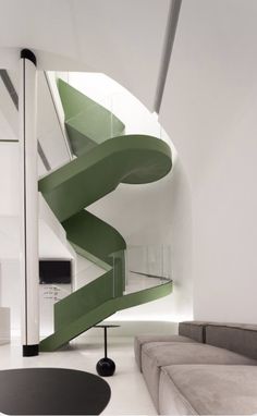 a living room with a spiral staircase next to a couch