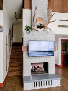 a fireplace with a deer head mounted above it