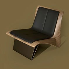 a black leather chair sitting on top of a wooden table next to a brown wall