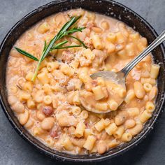 a bowl filled with macaroni and cheese on top of a gray countertop