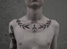 a man with tattoos on his chest has the words ommt written in small letters