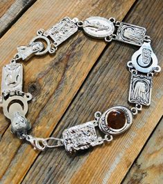 Silver charm mix bracelet with our lady and catholic saints all the way around. Each of the 10 charms are two sided so can be worn either way. The charms are linked with silver plated jumprings, and finished off with a lobster claw clasp. I can make them custom lengths, otherwise standard Length is approx. 8” Makes a great gift for all!  I can make as many as you would like! Handmade Silver Rosary Bracelet For Spiritual Use, Nickel Free Silver Metal Rosary Bracelet, Adjustable Silver Spiritual Jewelry And Charms, Spiritual Engraved Silver Rosary Bracelet, Bohemian Silver Rosary For Jewelry Making, Silver Bohemian Rosary Bracelet Gift, Silver Rosary Bracelet With Charms As Gift, Handmade Silver Spiritual Rosary Bracelet, Adjustable Silver Rosary Bracelet With Charms