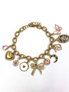 Coquette Charm Bracelet Details>> This coquette bracelet is a great addition to your coquette jewelry collection or to lean into coquette style for a feminine edge🎀 * This gold charm bracelet is made with a 304 stainless steal 18K gold plated chain and gold plated charms. * Listing includes one bracelet with 10 charms. Chain is 7 and 1/8" long with the extender chain. a longer extender chain can be added upon request under the personalization section to fit larger length wrists. * All orders are final as these are MADE TO ORDER. If you have any concerns with your order, feel free to reach out!  🎀 Charm Bracelet Care Tips>>  - Clean with soft linen cloth or jewelry cloth regularly. - Avoid exposing bracelets to water, lotions, creams, soaps, etc. or leaving them outside in direct sunlight Coquette Bracelet, Charm Bracelet Diy, Coquette Jewelry, Charm Bracelet Gold, Lucky Charm Bracelet, Dainty Gold Bracelet, Bracelet Elegant, Coquette Style