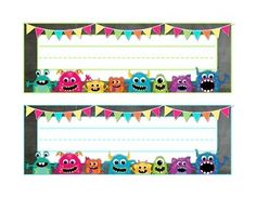 two monster themed name tags with buntings and flags on the bottom, one for each