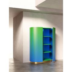 a blue and green cabinet in an empty room