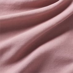 a close up view of the fabric on a pink shirting material that is very soft