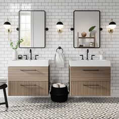 a bathroom with two sinks and three mirrors on the wall next to each other,