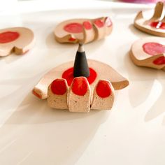 a group of wooden pieces with red paint on them sitting on top of a table