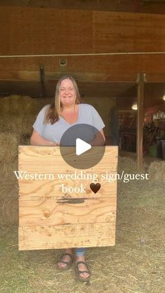 a woman holding a wooden box with the words western wedding signquest book