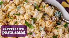 a bowl filled with pasta salad and topped with parsley on the side text reads street corn pasta