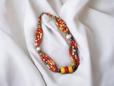 Elevate your style with our stunning Berber Necklace, inspired by the rich heritage of the Tuareg people. Crafted with exquisite detail, this necklace features a captivating array of multi-colored stones accented with vibrant coral, echoing the vibrant spirit of North African craftsmanship. Each bead tells a story of cultural significance, celebrating the resilience and beauty of Berber tradition. Whether you're adding a pop of color to your everyday look or seeking a statement piece for special Bohemian Faceted Beads, Gems, And Cabochons For Gifts, Bohemian Faceted Beads For Gifts, Bohemian Beaded Necklaces With Faceted Beads For Festivals, Festive Multicolor Oval Beads Jewelry, Bohemian Multicolor Beads And Cabochons For Festivals, Bohemian Multicolor Beaded Beads Gems And Cabochons, Bohemian Multicolor Beaded Gems And Cabochons, Artisan Multicolor Necklaces With Spacer Beads, Bohemian Colorful Beads For Festivals