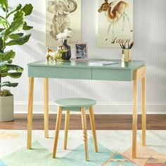 a white desk with two stools in front of it and a potted plant